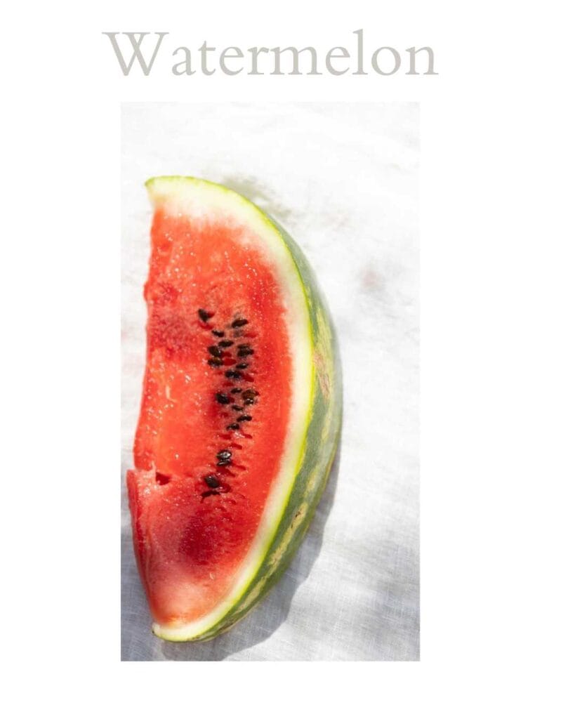 A vertical slice of watermelon photographed against a soft white background